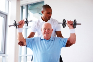 nurse and elderly man doing physical therapy